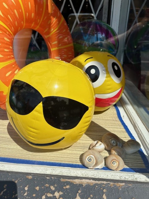 emoji beach balls in a shop window